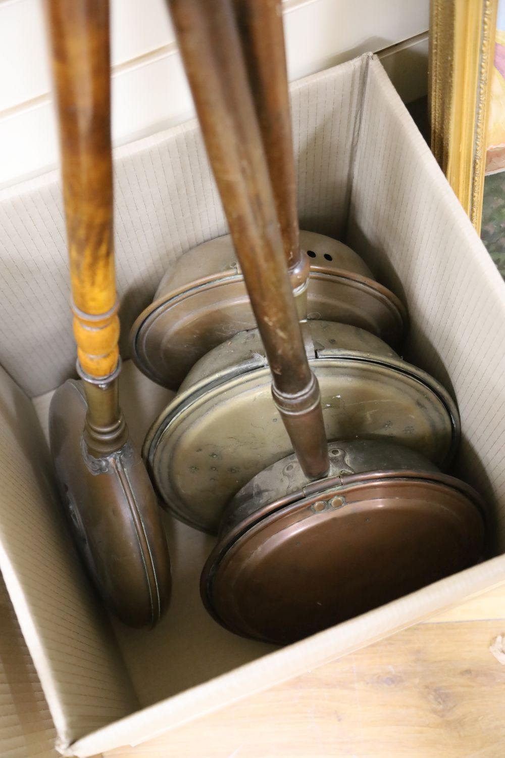 Three copper bed warming pan and a brass ditto